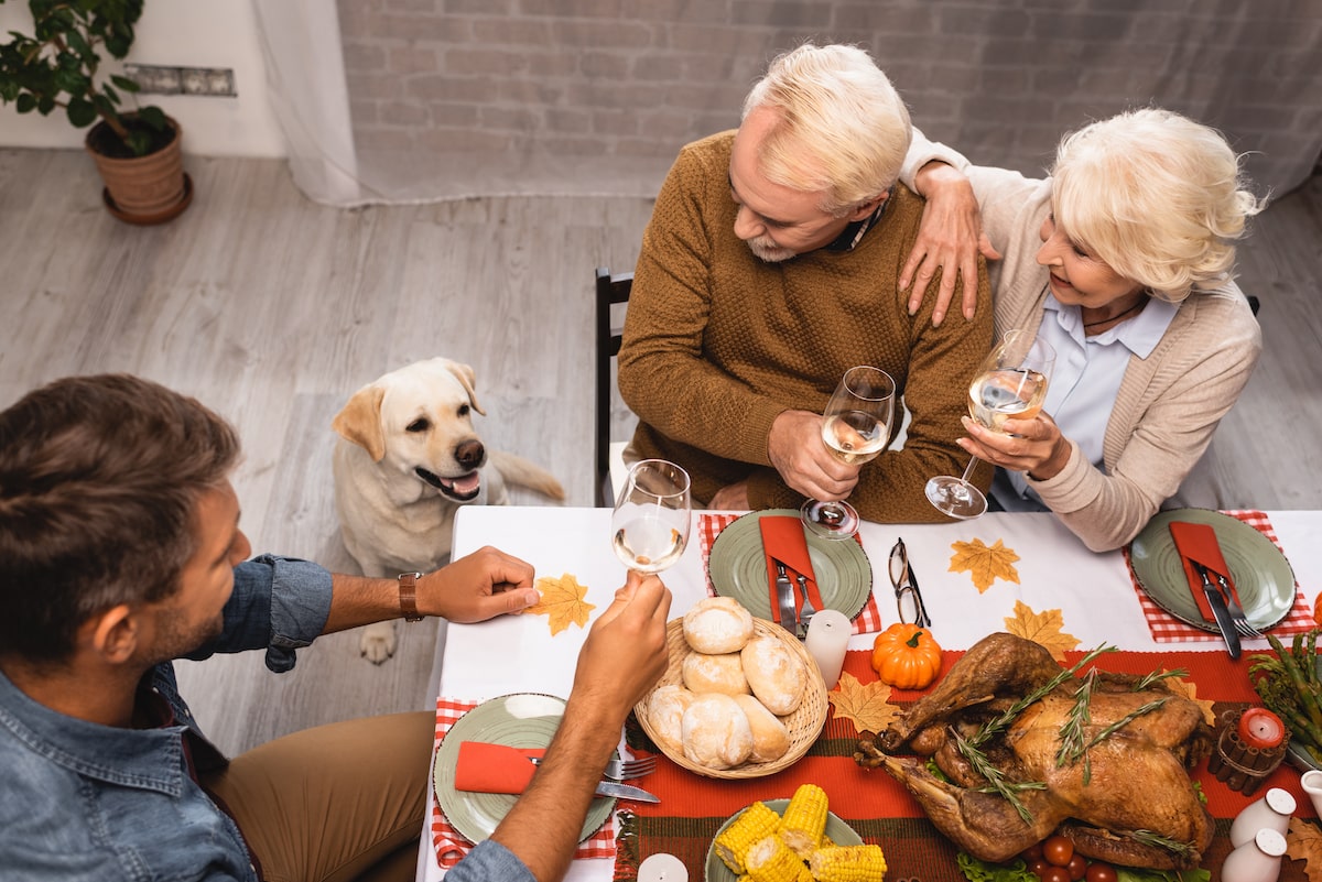 family with dog on thanksgiving